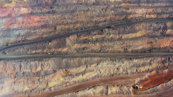 Huge Belaz Trucks Driving on the Pit Bottom in Mining Factory Mine Quarry in Ukraine