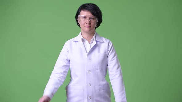 Happy Beautiful Woman Doctor Wearing Protective Glasses with Arms Crossed