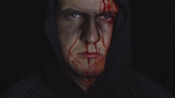 Man Executioner Halloween Makeup and Costume. Guy with Blood on His Face