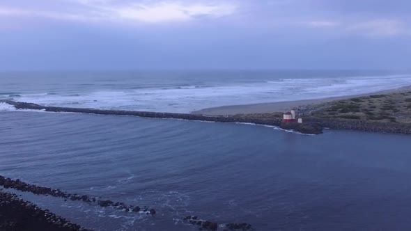 Coquille River lighthouse drone footage taken during sunset, where Pacific Ocean meets the Oregon co