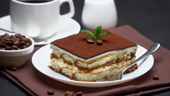 Portion of Traditional Italian Tiramisu dessert, cream or milk and cup of espresso coffee