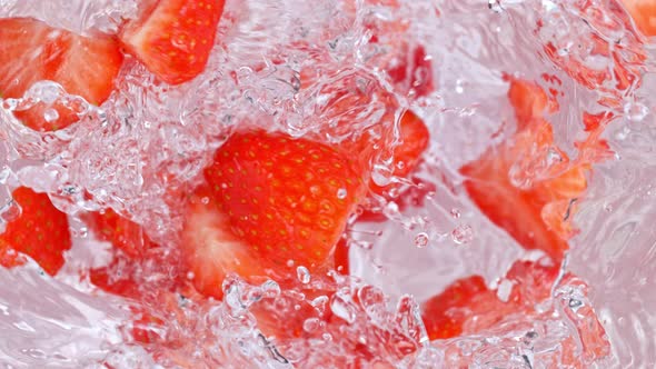 Super Slow Motion Shot of Strawberries Falling Into Water Whirl at 1000 Fps