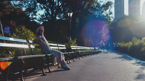 Young girl sitting on a park bench