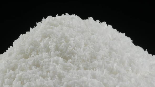 close up of a coconut and grounded coconut flakes