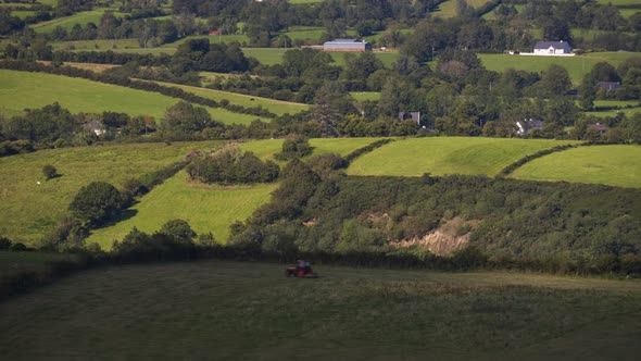 Time lapse of rural agriculture landscape on sunny summer day with tractor running down the field in alt