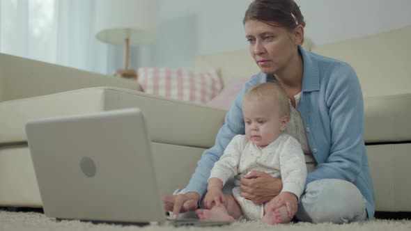 Beautiful Adult Woman Mother With Little Child Works Home