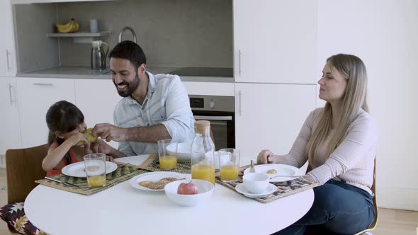 Parents Couple and Little Girl Having Breakfast Together