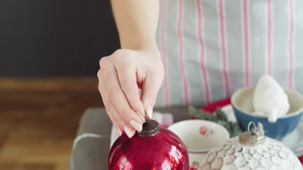 Christmas Table Decoration. Festive Table Setting. Female Hands Decorate the Table for Christmas