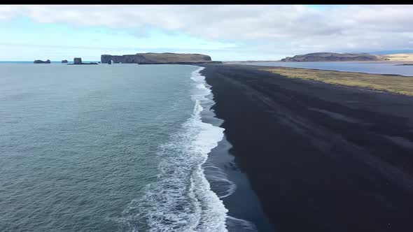 Waves in the ocean. Black sand. Black beach. Waves on the black sand. The nature of Iceland.