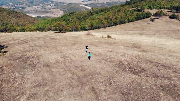 two kids running in the field, village Brus, Kosovo