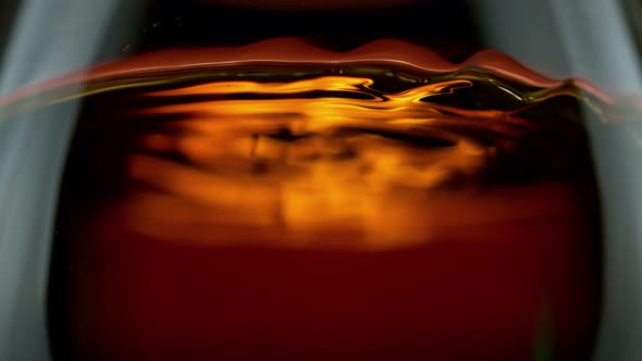 Super Slow Motion Detail Shot of Rippling Whiskey in Glass at 1000Fps