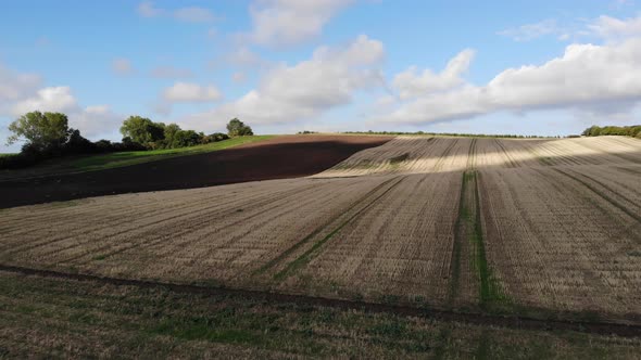 Aerial view of golden fields with brown mold close to Sejerøbugten in Odsherred.