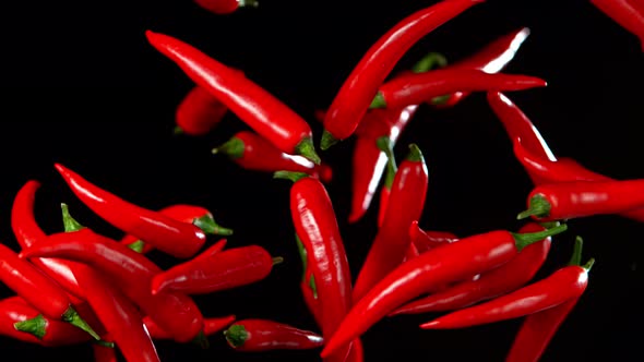 Super Slow Motion Shot of Flying Red Chilli Peppers in the Air at 1000Fps