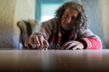 euro coins in conceptual image of poverty. Focus to the coins.