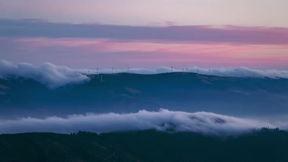 Wind power turbines using the power of nature to create green energy during the sunset