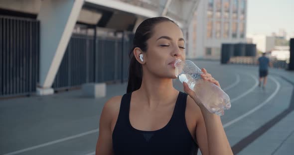 Beautiful Young Athletic Woman Drinking Water From Bottle After Gym Outdoor Workout City Sport