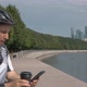 Man Sportswear Riding a Bicycle Helmet Is Resting on a Beautiful City Promenade - VideoHive Item for Sale