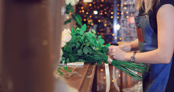 Florist Collects Beautiful Flowers in a Bouquet Flower Shop Girl Works to Order Make a Festive