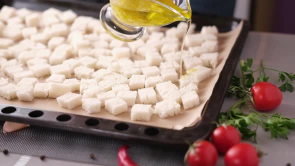 Making Caesar Salad Croutons  Pouring Garlic Sauce on Sliced Toast Bread in Baking Tray