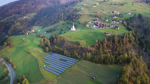 Aerial View of Solar Panels on Green Hills