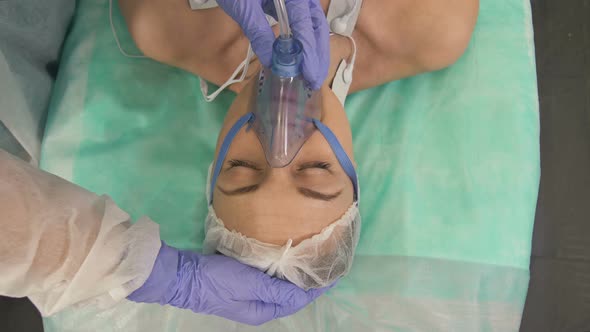 Doctors Putting an Oxygen Mask on Patient in Hospital