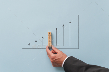 essman making a chart with upwards pointing arrows. Over blue background.