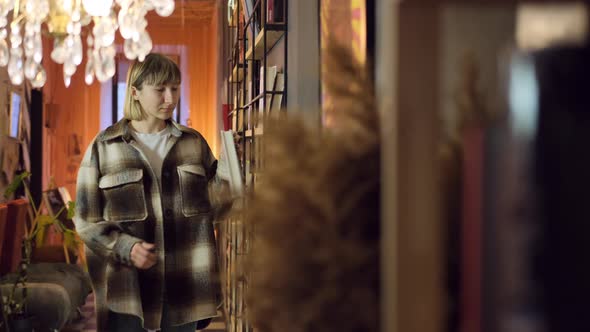 Woman Reading Book in Library