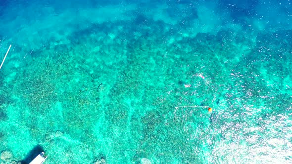 Tropical aerial abstract view of a white paradise beach and aqua blue ocean background in 4K