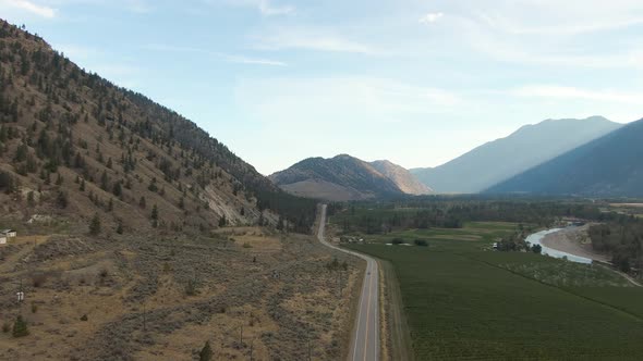 Aerial View of Scenic Road, Hwy 3, in the valley around the Canadian Mountain Landscape. Near Osoyoo