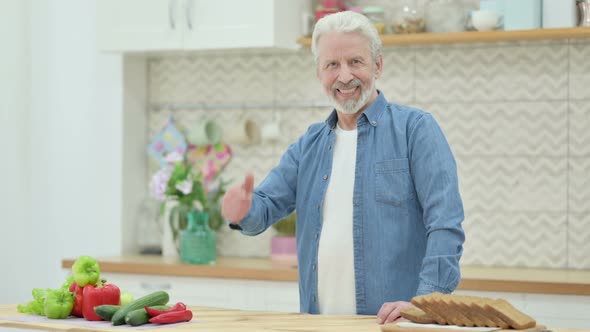 Old Man Showing Thumbs Up While Standing in Kitchen