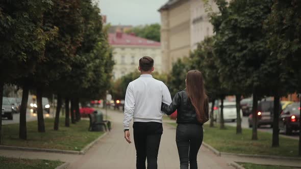 A Man and a Woman are Walking in the Park