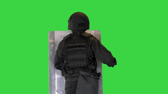 Riot Police Unit Making Sound Hitting Shield with Baton on a Green Screen Chroma Key