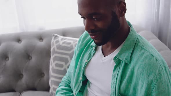 Young adult mixed race man enjoying time at home