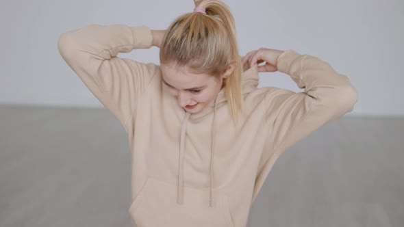 Cheerful Blond Woman in Hoodie