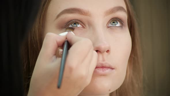 the Make-Up Stylist Doing a Make-Up to Hipster Model