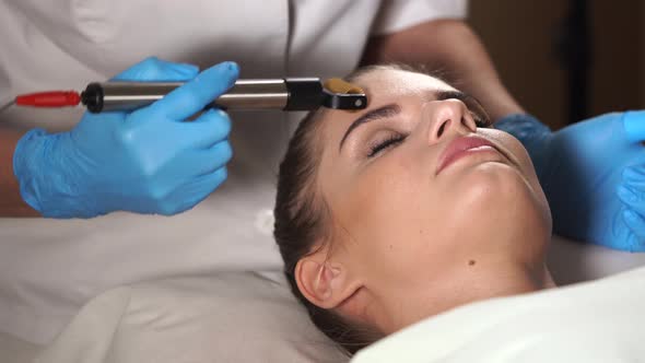 Woman in Spa Salon Getting Facial Rejuvenation Procedure