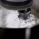 Electric mixer whipping cream in steel mixing bowl, close-up in slow motion - VideoHive Item for Sale