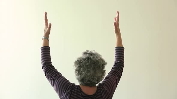 Woman Doing Thriver Pose Yoga with Palms Open