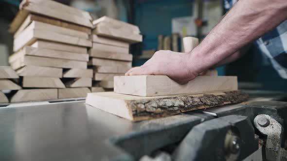 Closeup of Hands and Wood Workpiece on Planer