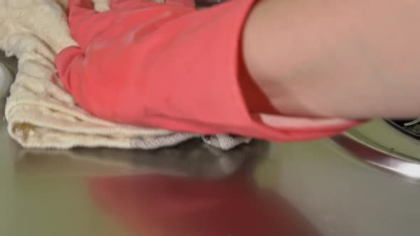 Woman in Gloves Washes and Rubs a Gas Stove with Detergent Until It Shines