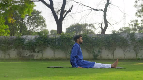 Indian man doing yoga in a park