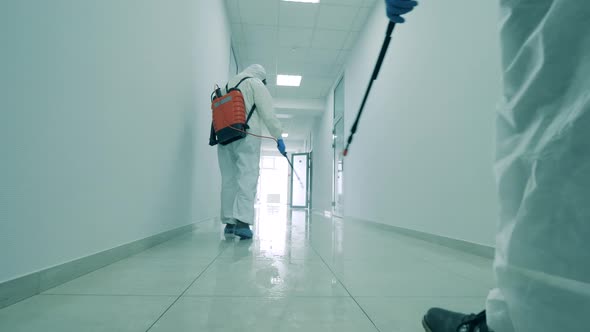 Professional Cleaners Sanitize Floor and Walls in Building.