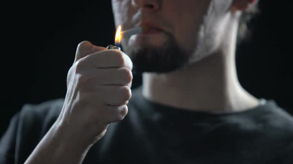 Confident Young Man Lighting Up Cigarette, Bad Unhealthy Habit, Addiction