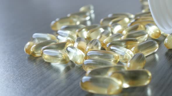 Slow pan on transparent omega-3 soft gel capsules  4K 2160p 30fps UltraHD footage - Fish oil supleme