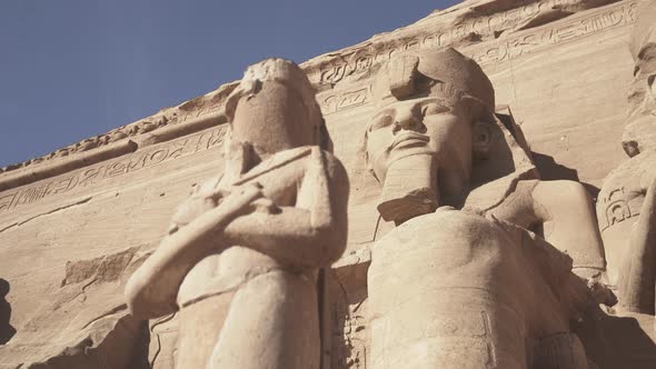 Low shot of the Abu Simbel facade with big statues of Osiris.