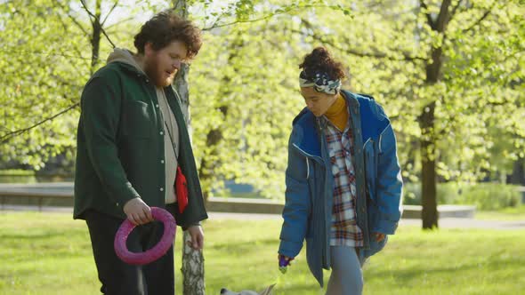 Dog Owners Walking in Park