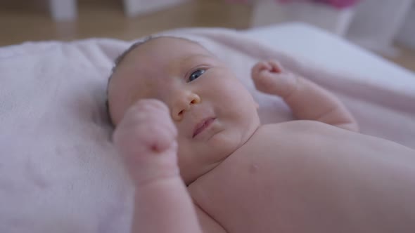 Portrait of Curios Newborn Baby Girl Looking Away Start Crying