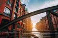 The red brick warehouse - Speicherstadt district in Hamburg Germany, framed by steel bridge arch - PhotoDune Item for Sale