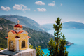 Colorful shrine Proskinitari on pedestal. Amazing sea view to Greece coastline in the background - PhotoDune Item for Sale