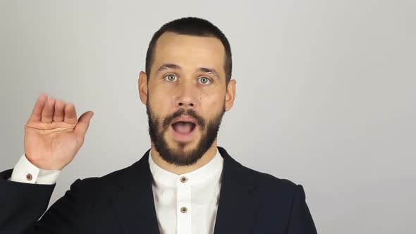 Young Handsome Businessman in Blue Suit Says Goodbye To the Client and Waves His Hand. Young